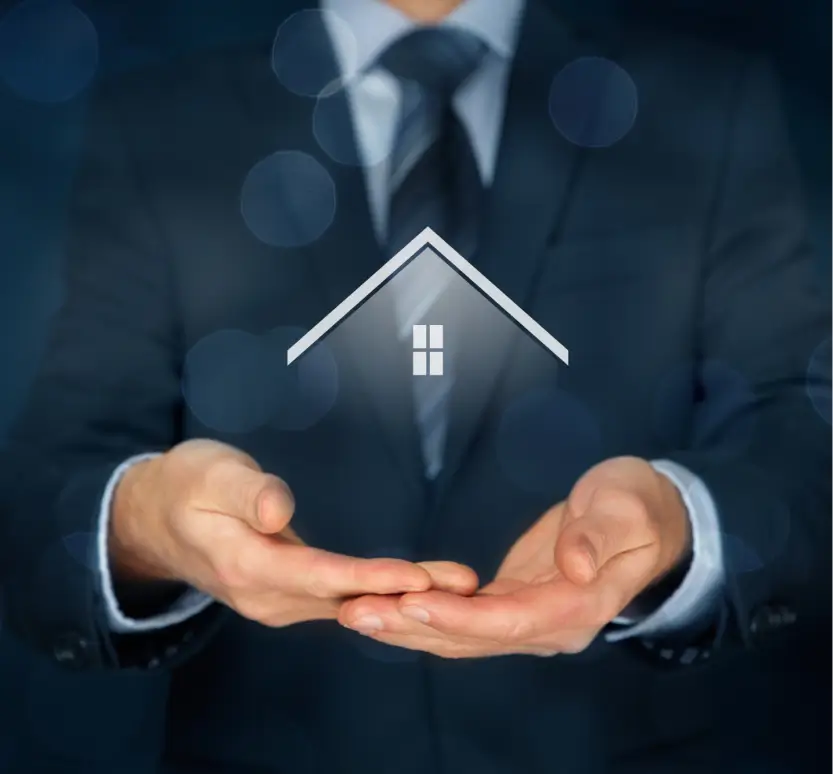 a businessman holding a house in his hands