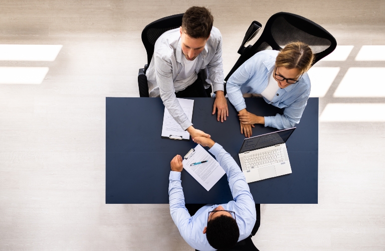 Real estate lawyer sorts out documents with clients
