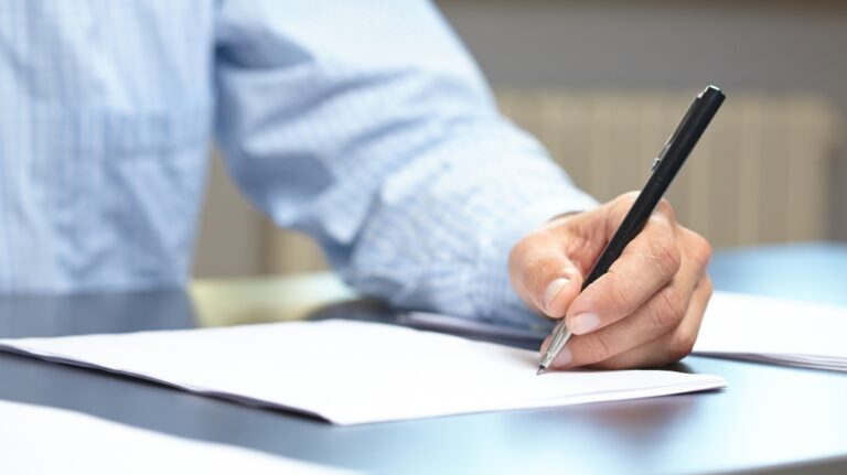 men with pen and documents